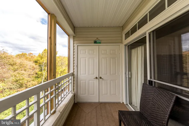 a view of a balcony with wooden floor