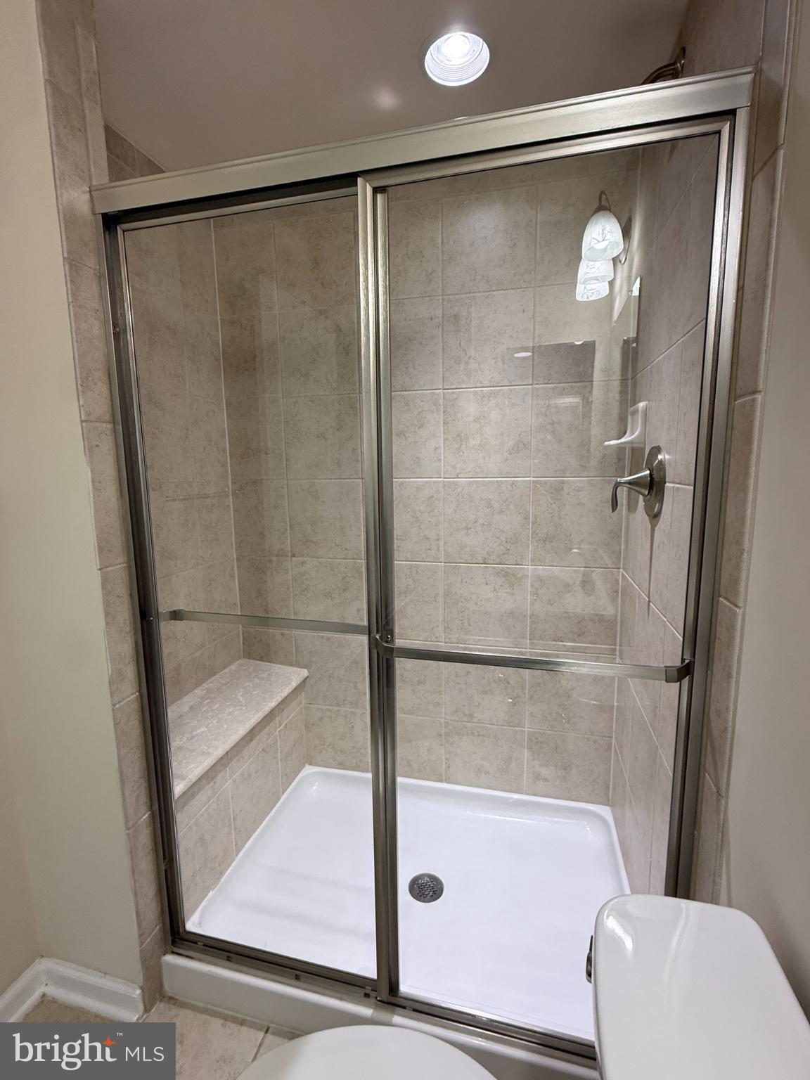 7018 Foxton Way Hanover, MD 21076 - Photo 11 of 72 a bathroom with a shower and toilet