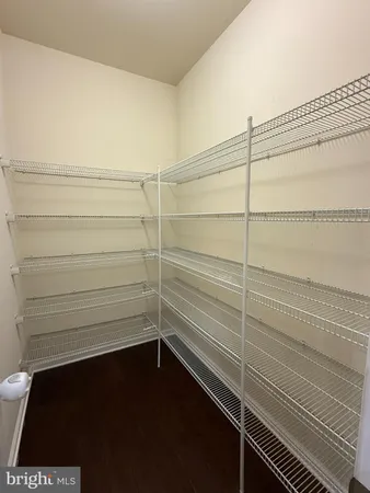 a view of an empty room with a ceiling fan