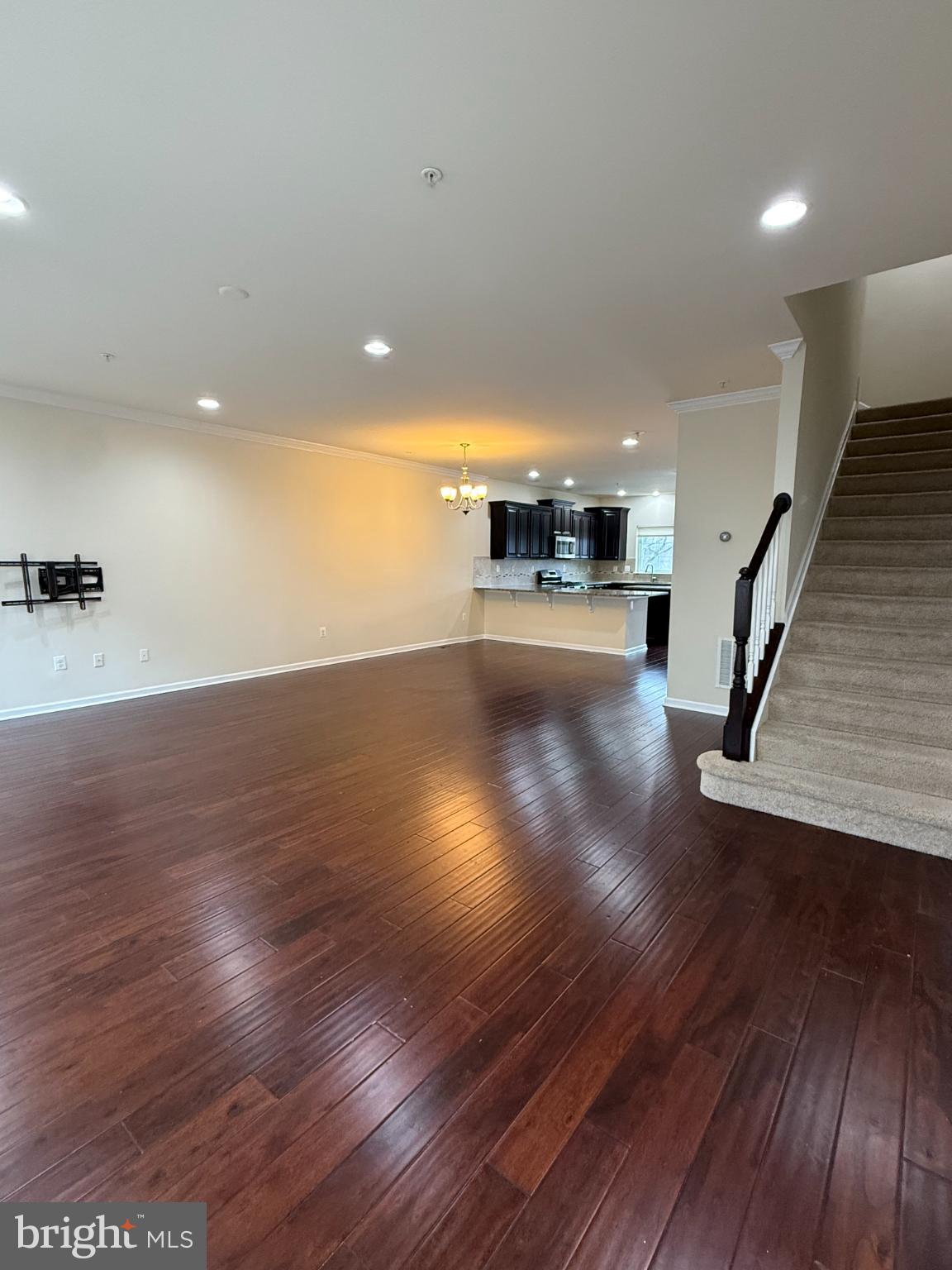7018 Foxton Way Hanover, MD 21076 - Photo 29 of 72 an empty room with wooden floor and staircase