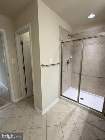 a white toilet sitting next to a shower