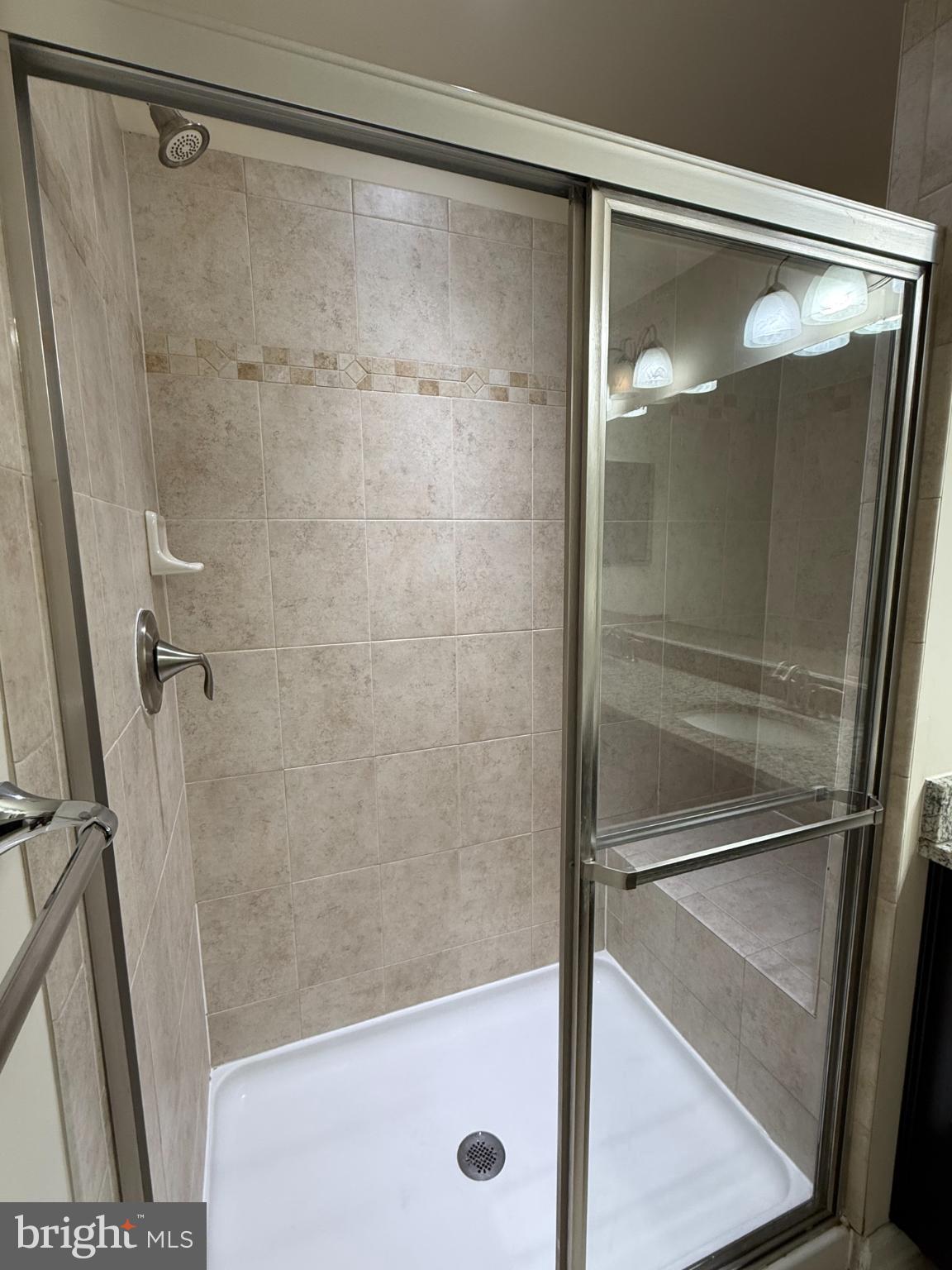 7018 Foxton Way Hanover, MD 21076 - Photo 40 of 72 a bathroom with a glass shower door