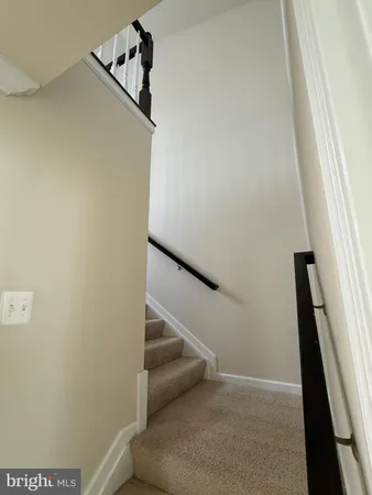 a living room with furniture a flat screen tv and a large window