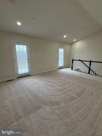 a view of a park that has a sign board large trees