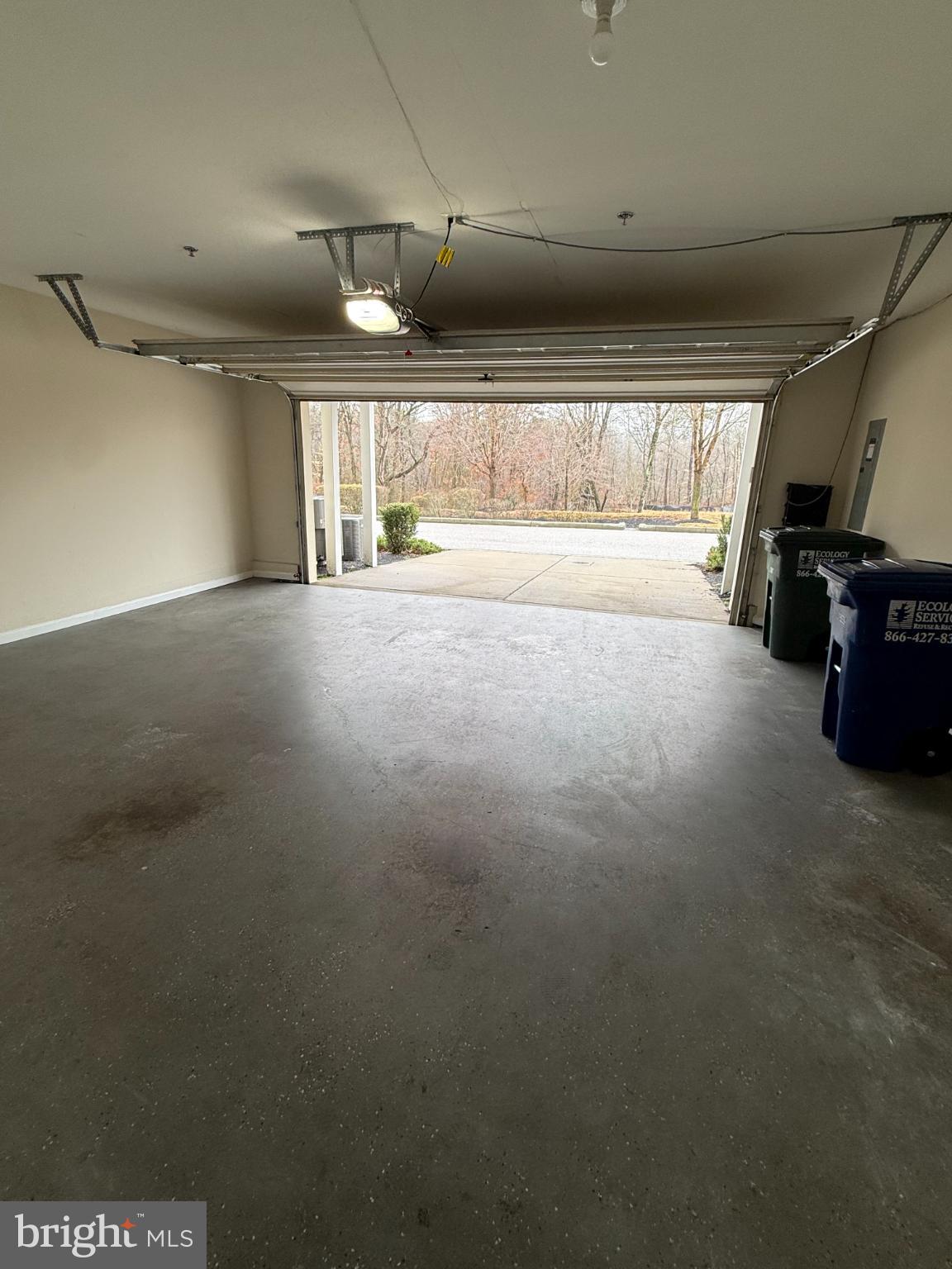 7018 Foxton Way Hanover, MD 21076 - Photo 59 of 72 Spacious garage with serene outdoor view.