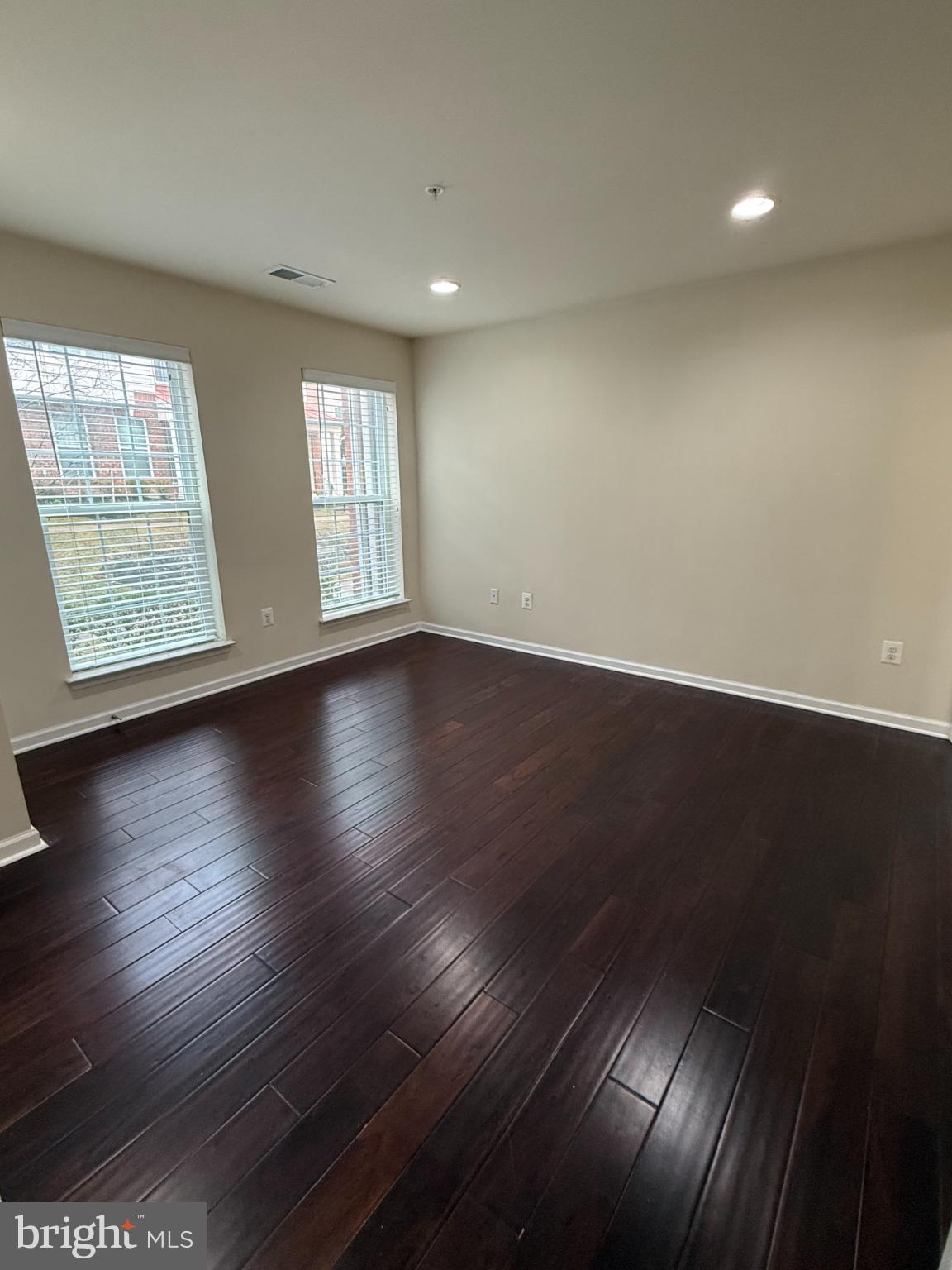 7018 Foxton Way Hanover, MD 21076 - Photo 7 of 72 an empty room with wooden floor and windows