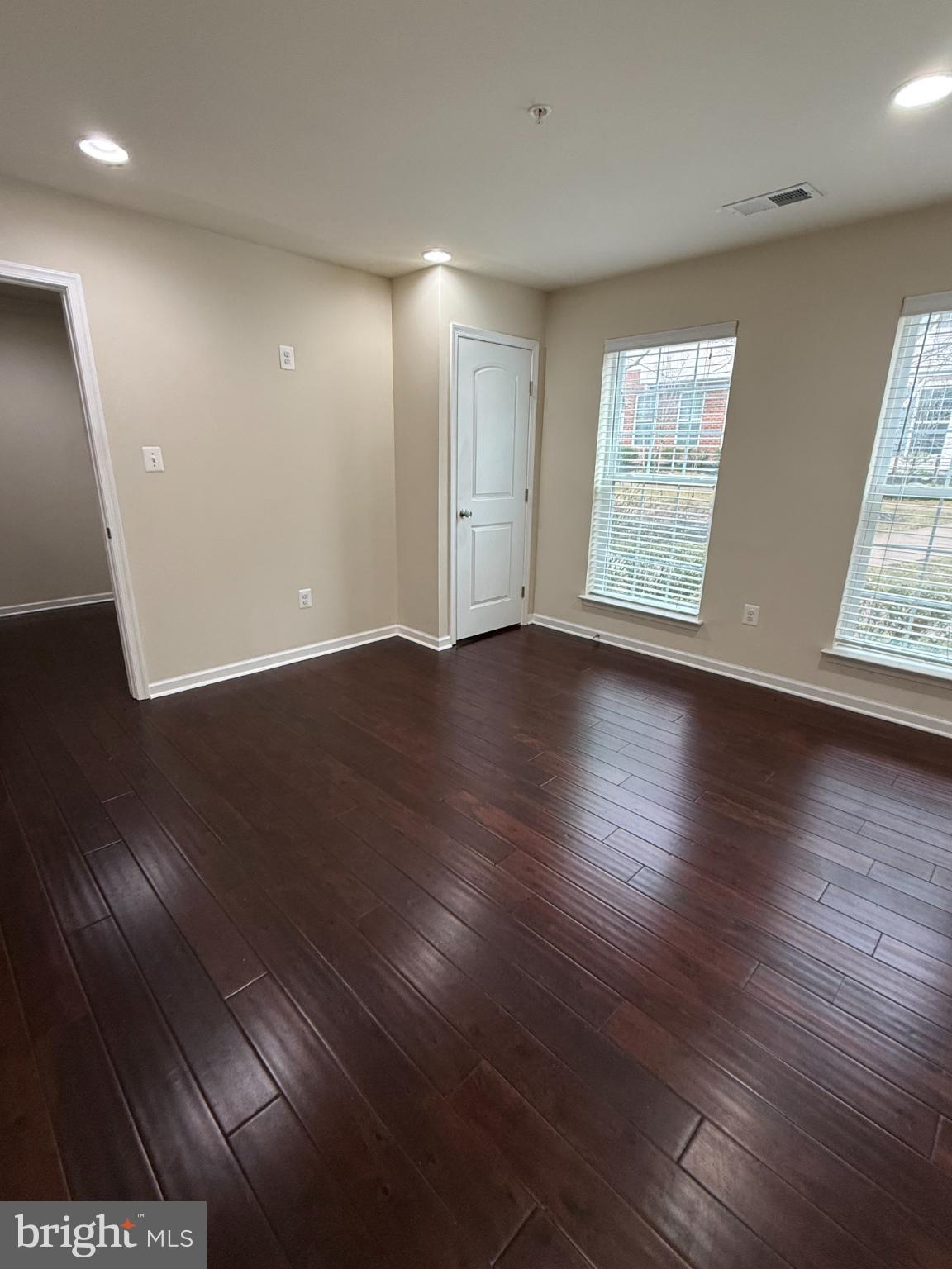 7018 Foxton Way Hanover, MD 21076 - Photo 8 of 72 an empty room with wooden floor and windows