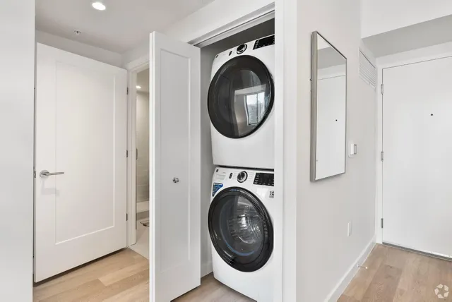 a view of a hallway with washer and dryer