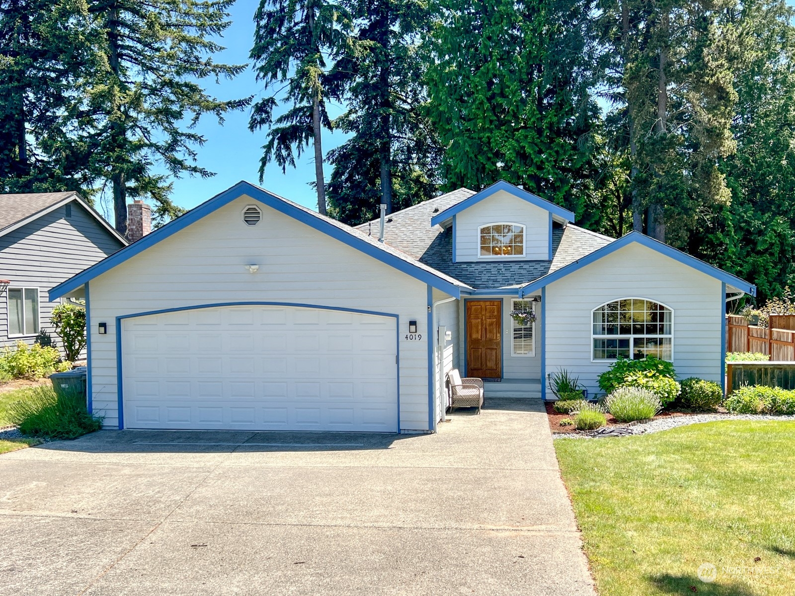 4019 Northeast 17th Street Renton, WA 98056 - Photo 1 of 37 a front view of a house with a yard and garage