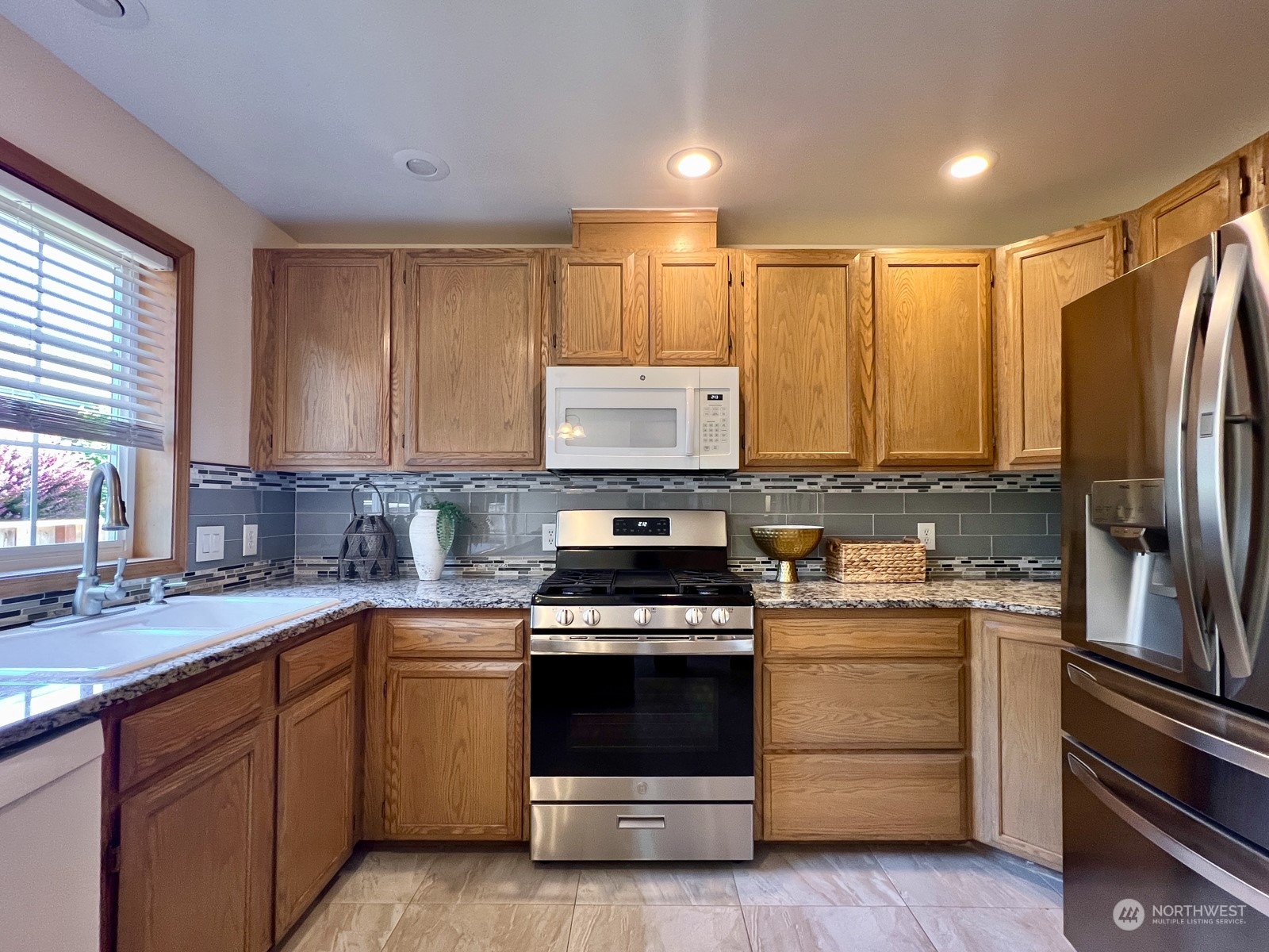 4019 Northeast 17th Street Renton, WA 98056 - Photo 13 of 37 a kitchen with a stove a sink and a refrigerator