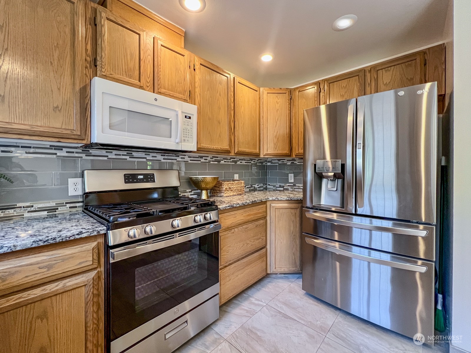 4019 Northeast 17th Street Renton, WA 98056 - Photo 14 of 37 a kitchen with stainless steel appliances granite countertop a stove a refrigerator and a microwave
