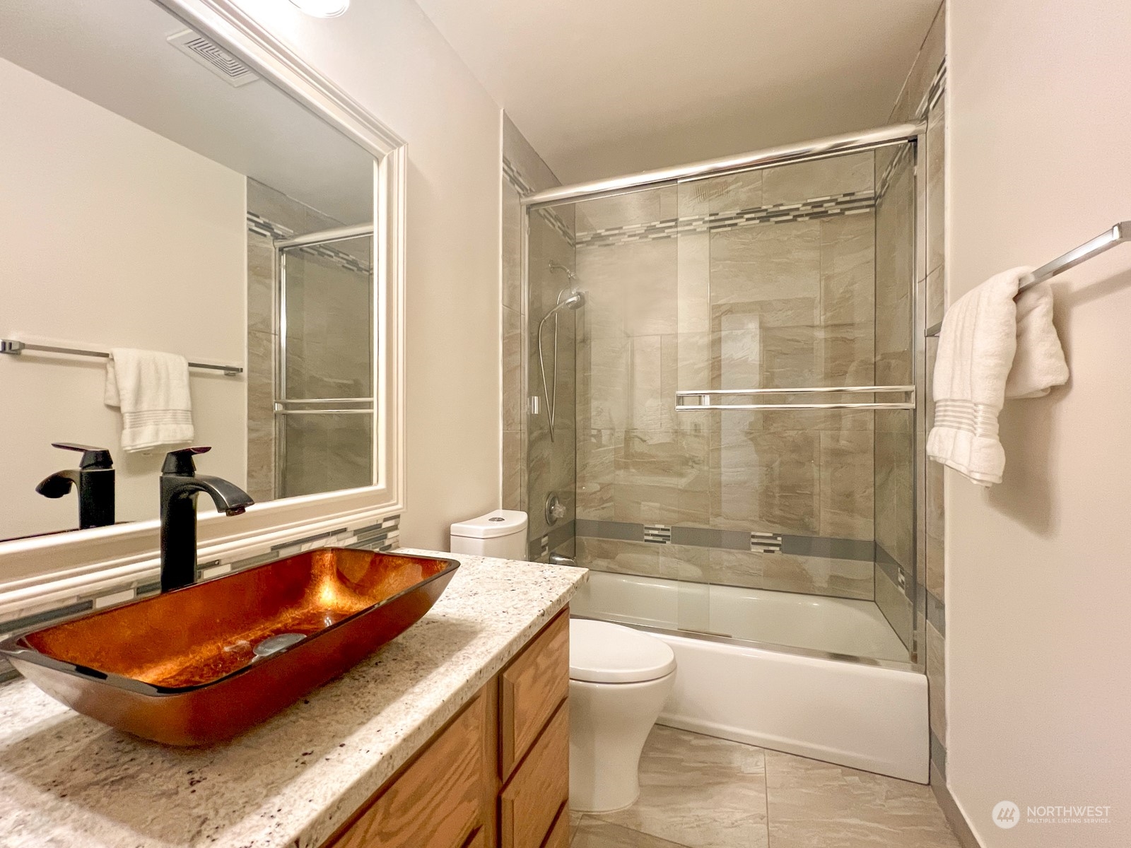 4019 Northeast 17th Street Renton, WA 98056 - Photo 19 of 37 a bathroom with a tub shower sink and toilet