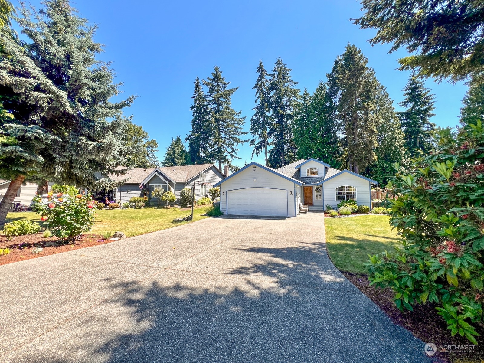 4019 Northeast 17th Street Renton, WA 98056 - Photo 36 of 37 a front view of a house with a yard and garage