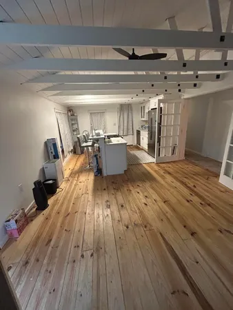 a view of a room with wooden floor