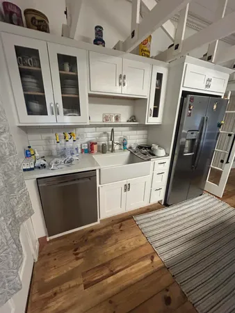 a kitchen with stainless steel appliances granite countertop a sink stove and cabinets