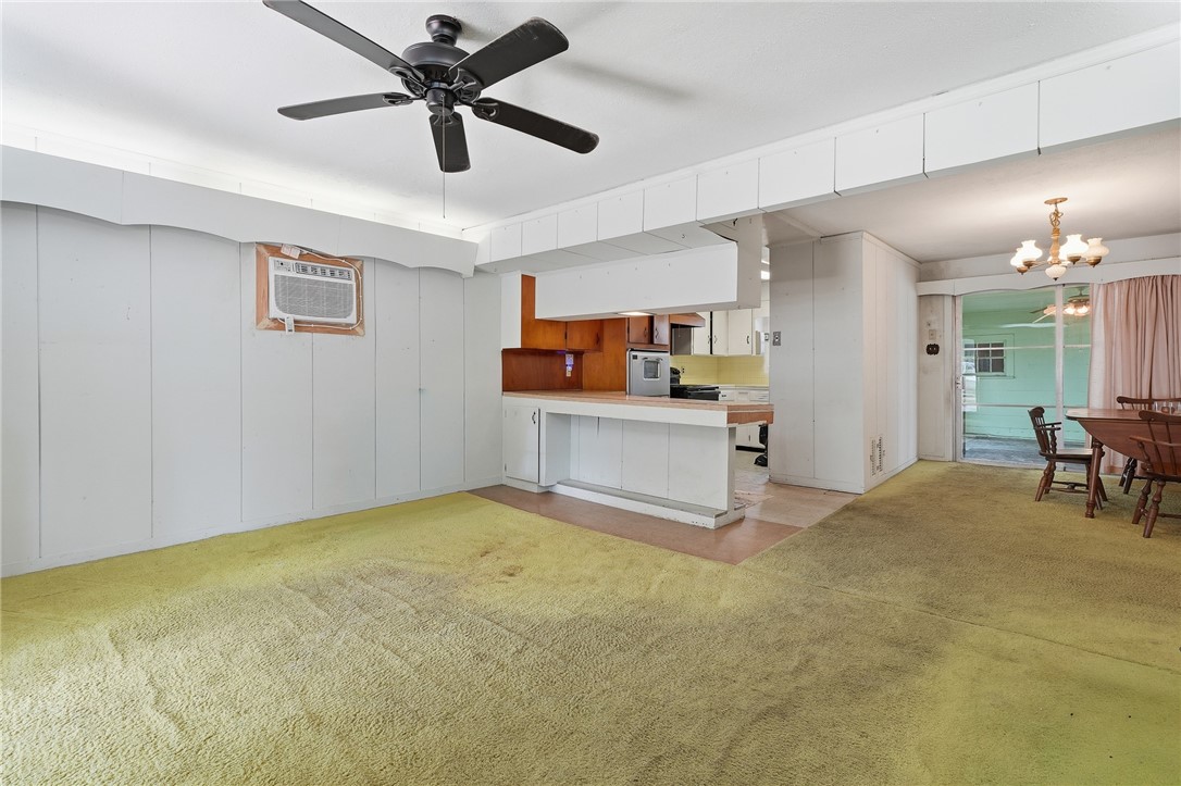 301 Laurel Street Fulton, TX 78382 - Photo 4 of 20 a view of a livingroom with a ceiling fan a kitchen a sink a ceiling fan and a rug