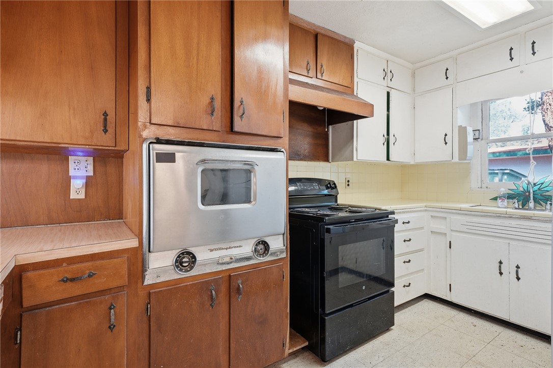 301 Laurel Street Fulton, TX 78382 - Photo 9 of 20 a kitchen with granite countertop cabinets stainless steel appliances and a counter space