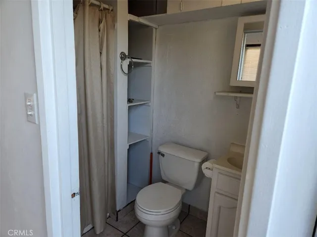 a living room with furniture and a air conditioner vent