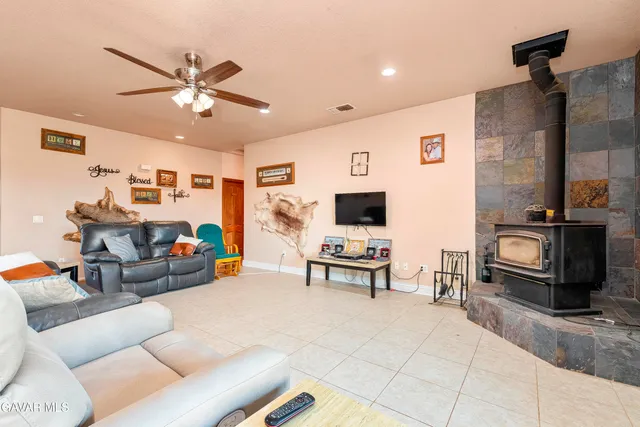 a bedroom with a bed a painting and a lamp