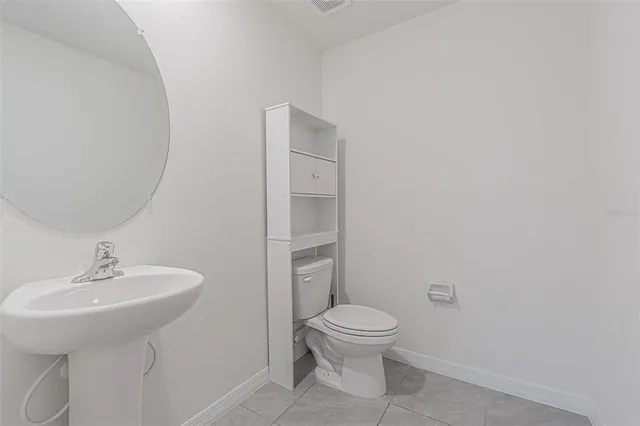 an empty room with closet and windows