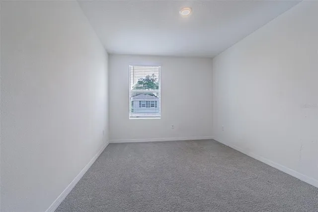 a view of a room with wooden floor and windows