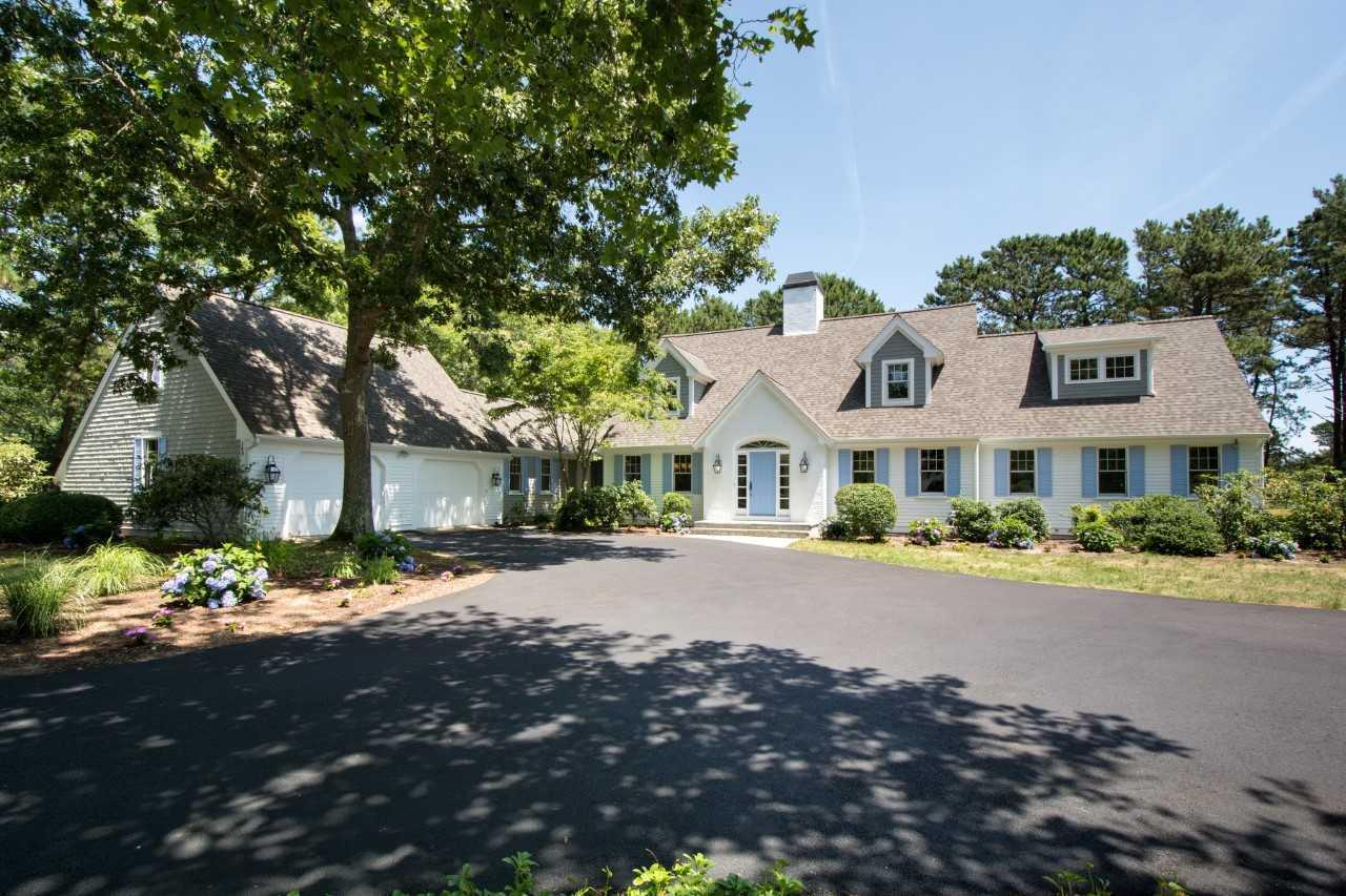 a front view of a house with a yard and a garage
