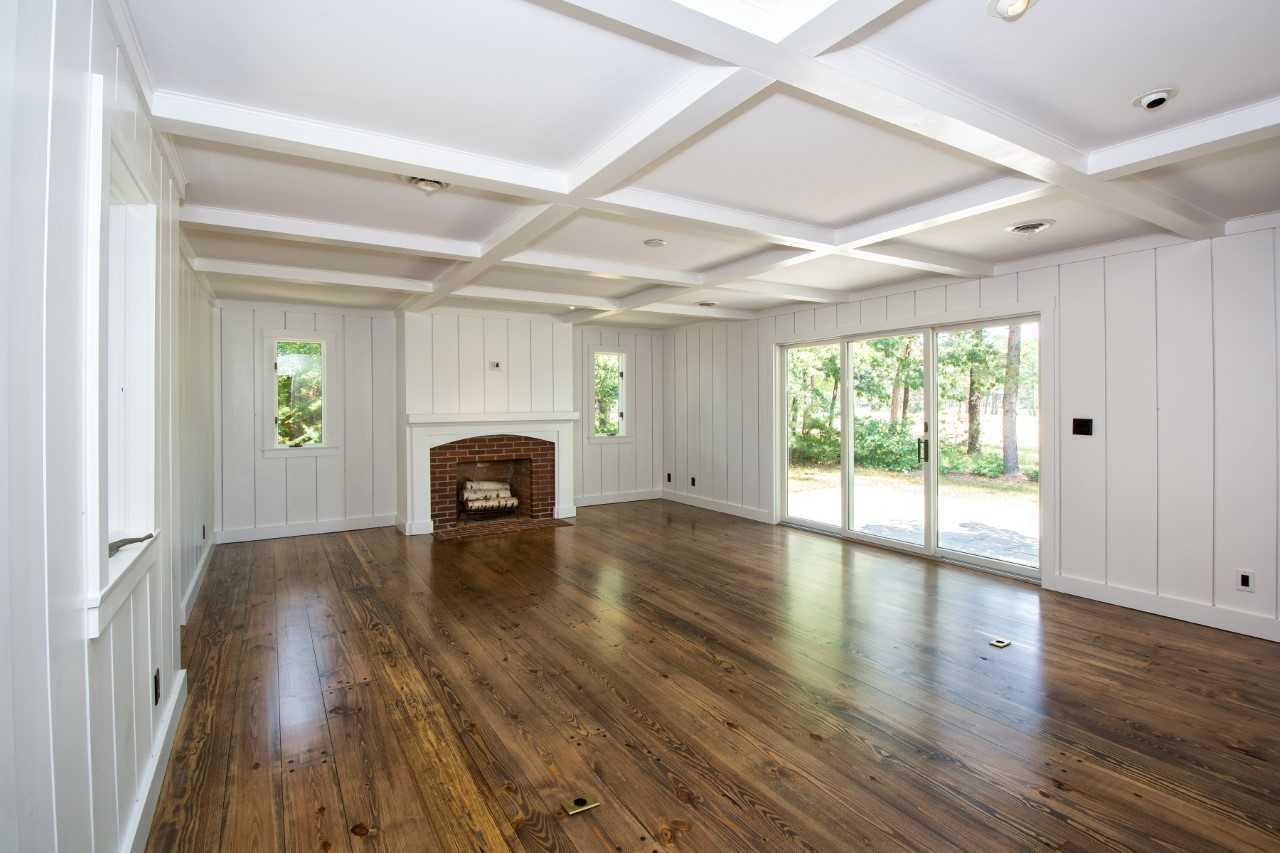 140 Pineleigh Path Osterville, MA 02655 - Photo 12 of 29 wooden floor in an empty room with a fireplace
