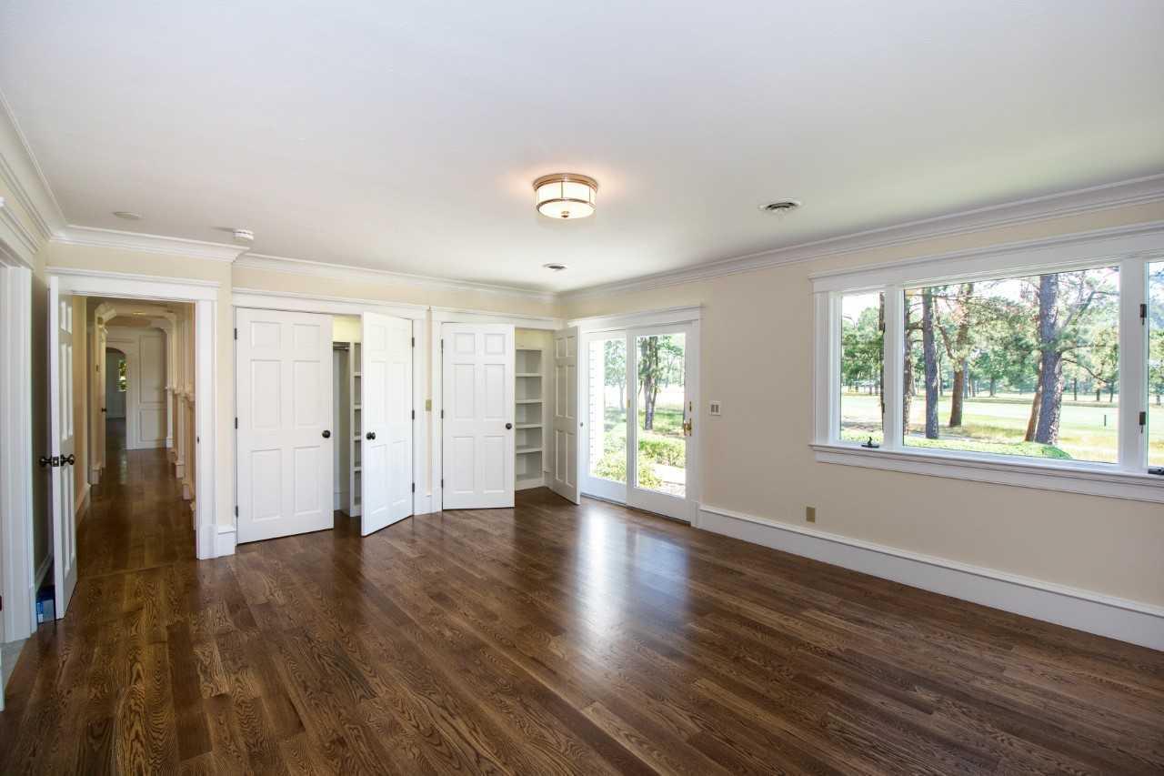 140 Pineleigh Path Osterville, MA 02655 - Photo 14 of 29 a view of an empty room with wooden floor and a window