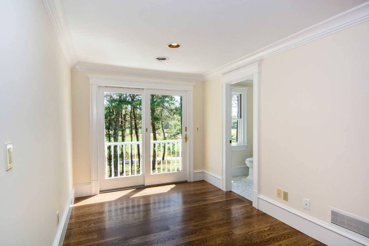 140 Pineleigh Path Osterville, MA 02655 - Photo 18 of 29 an empty room with wooden floor and windows