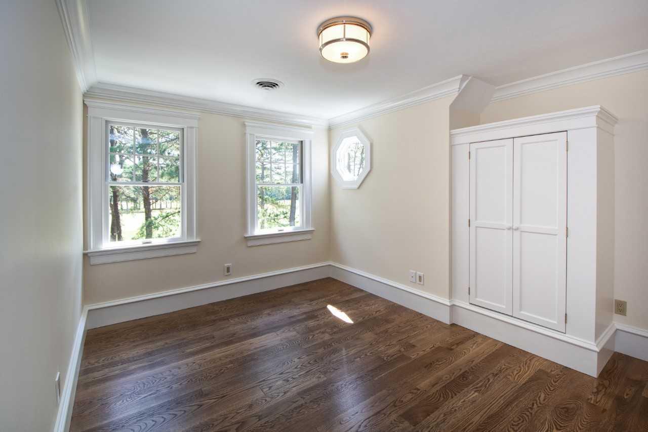 140 Pineleigh Path Osterville, MA 02655 - Photo 21 of 29 an empty room with wooden floor and windows
