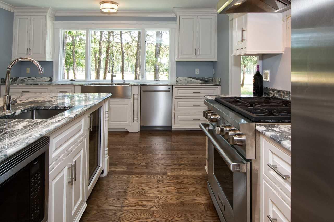 140 Pineleigh Path Osterville, MA 02655 - Photo 7 of 29 a kitchen with a stove a sink and a refrigerator