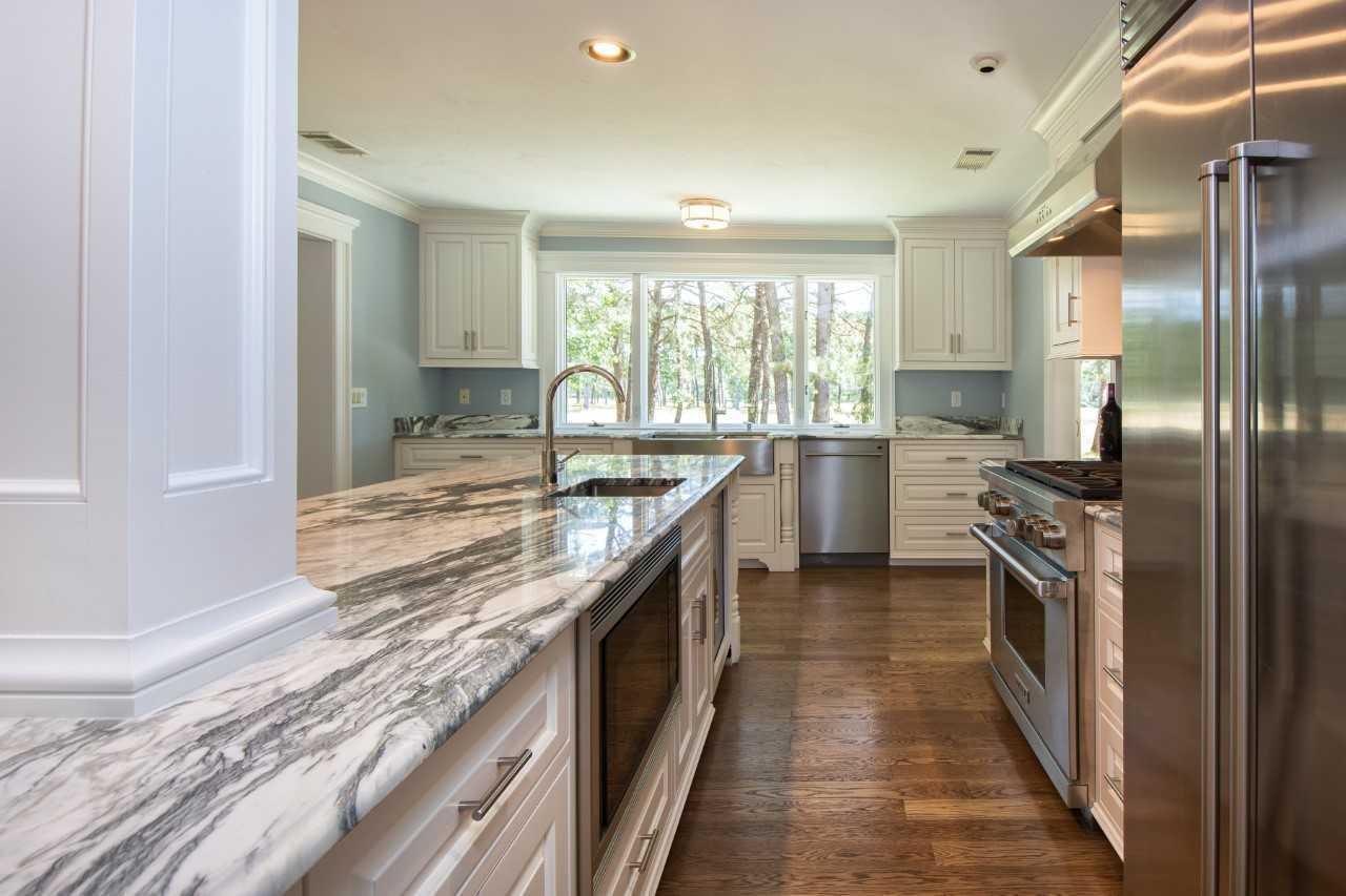 140 Pineleigh Path Osterville, MA 02655 - Photo 8 of 29 a kitchen with stainless steel appliances granite countertop a sink and a stove