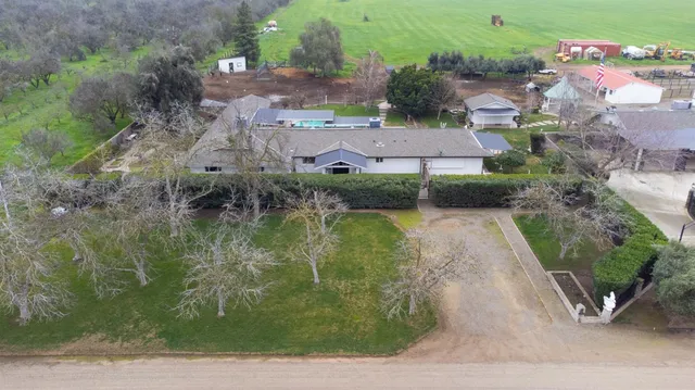 an aerial view of a house with outdoor space