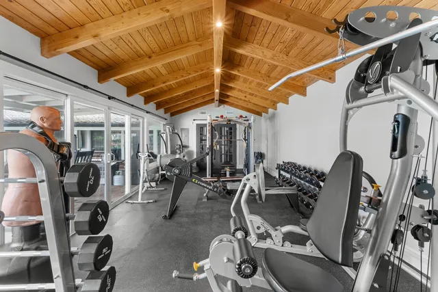 a work room with furniture and a flat screen tv