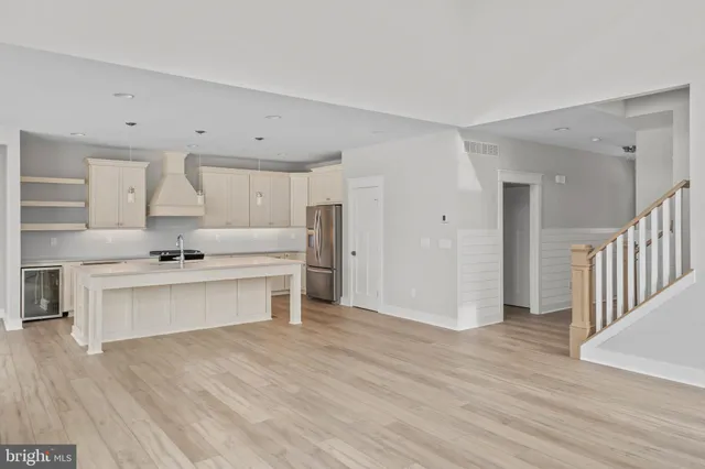 a view of kitchen with wooden floor and electronic appliances