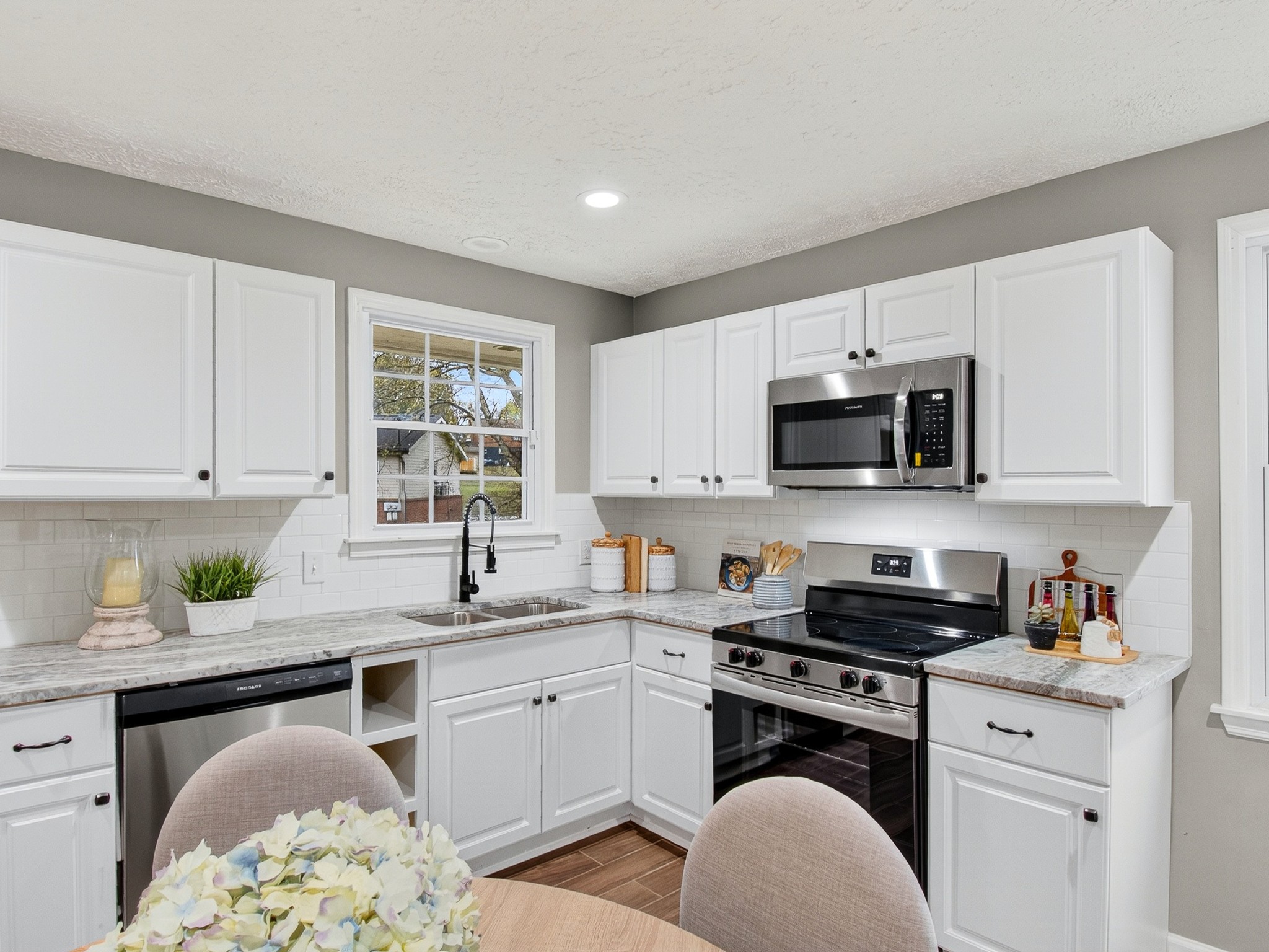 2509 Old Matthews Road Nashville, TN 37207 - Photo 14 of 45 a kitchen with stainless steel appliances granite countertop a sink dishwasher a stove and a microwave oven with cabinets