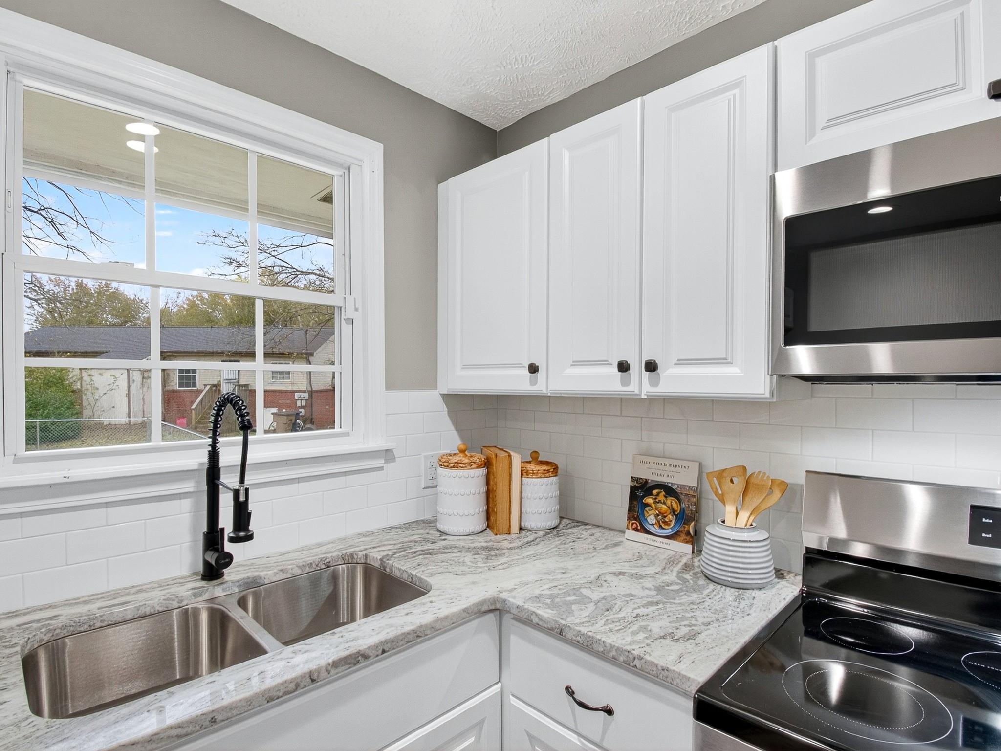 2509 Old Matthews Road Nashville, TN 37207 - Photo 17 of 45 a kitchen with stainless steel appliances granite countertop a sink a stove and a microwave