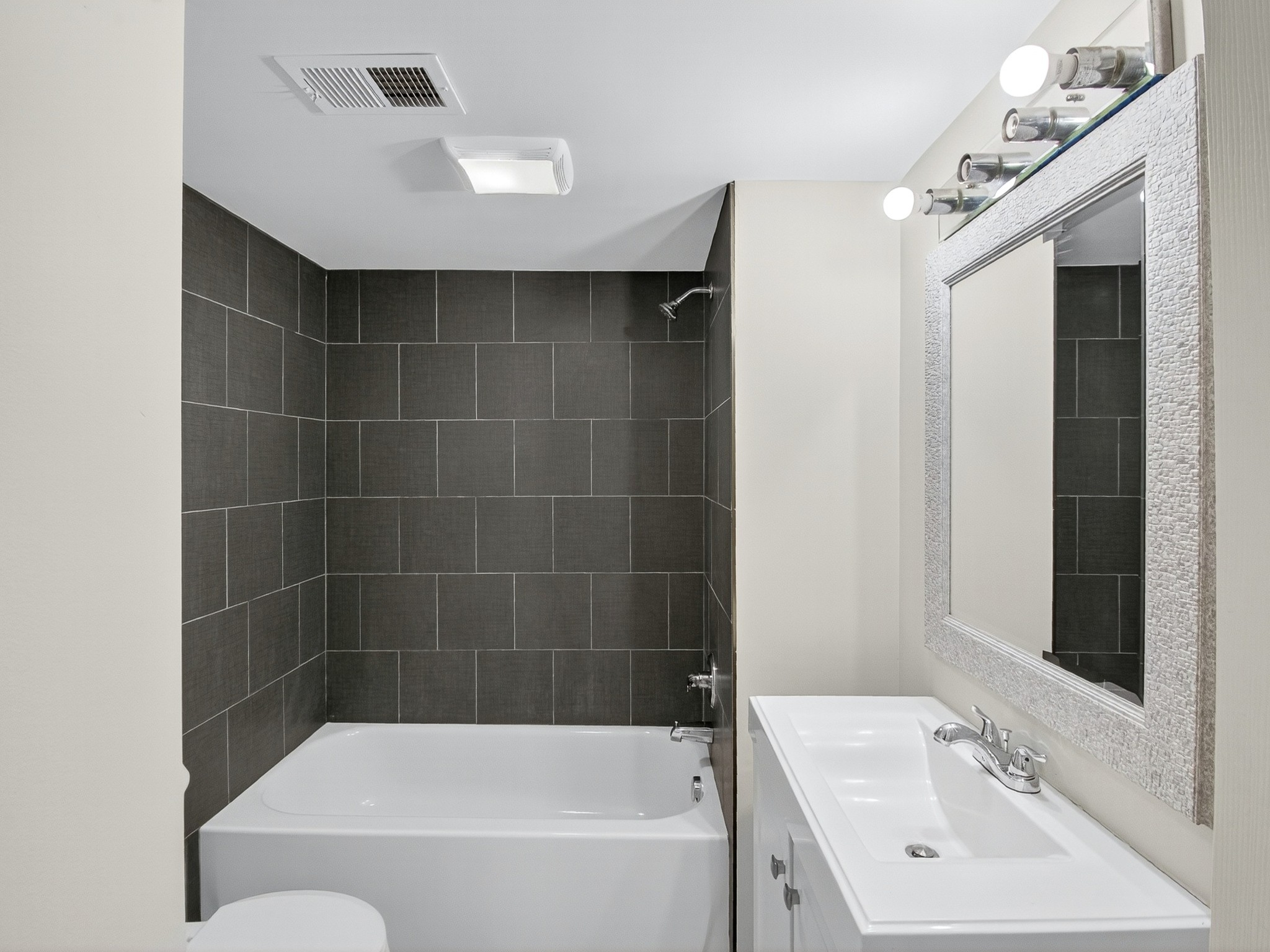 2509 Old Matthews Road Nashville, TN 37207 - Photo 33 of 45 a bathroom with a bathtub a sink a toilet a mirror and vanity
