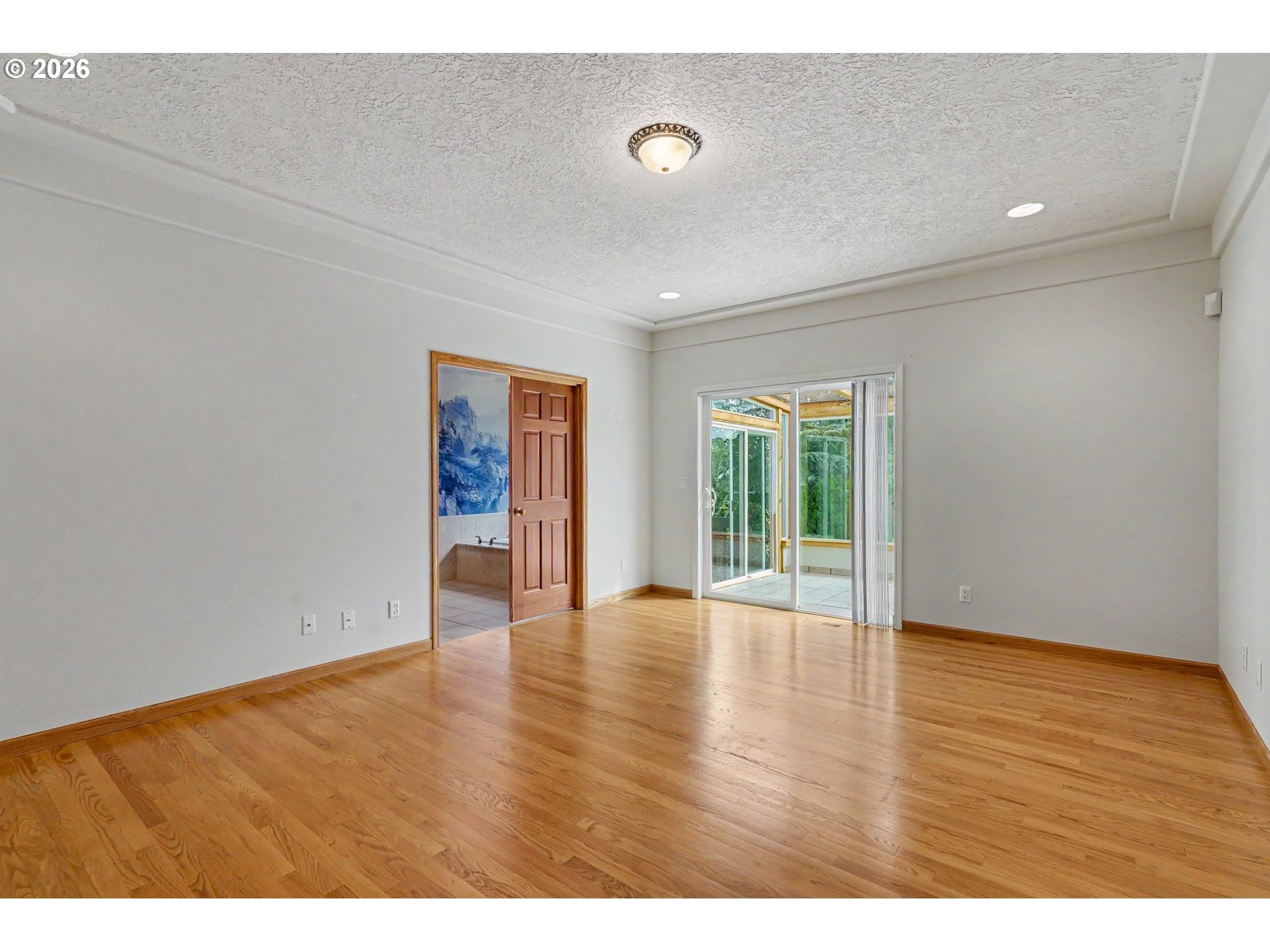 1470 Ranier Loop Northwest Salem, OR 97304 - Photo 30 of 48 a view of an empty room with wooden floor and a window