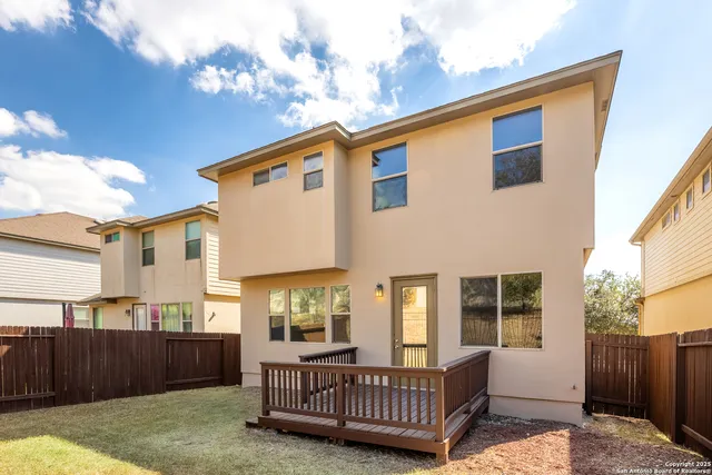 a view of a house with a wooden deck