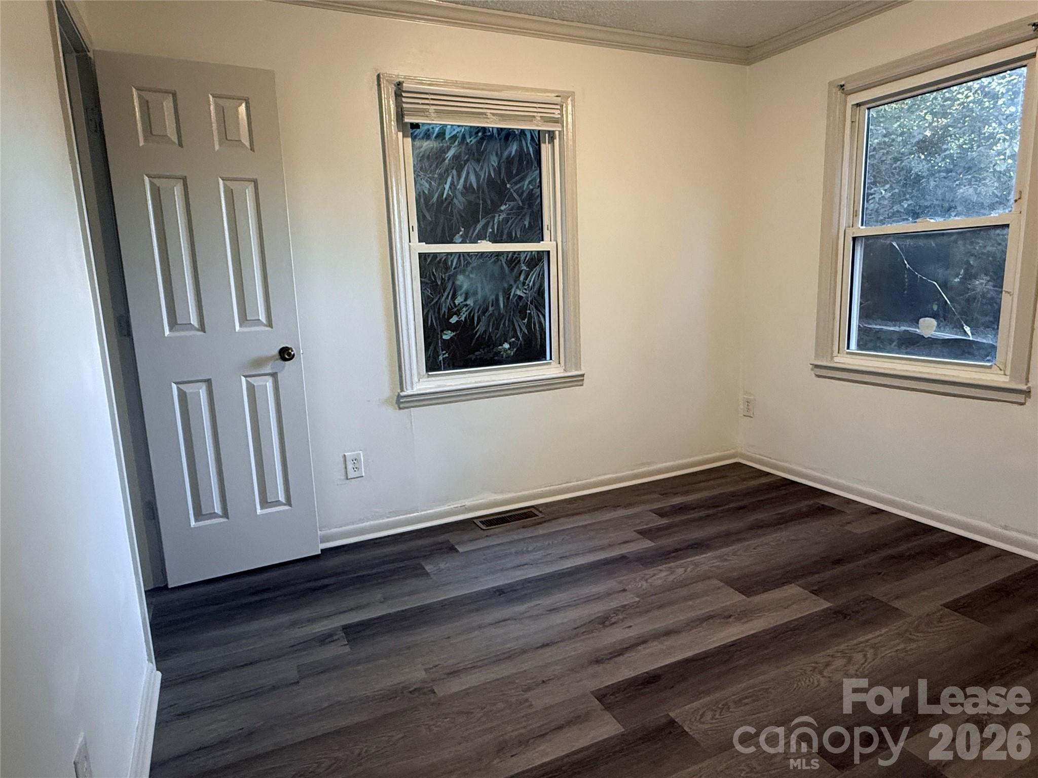 9225 Moores Chapel Road Charlotte, NC 28214 - Photo 11 of 19 a view of an empty room with wooden floor and a window