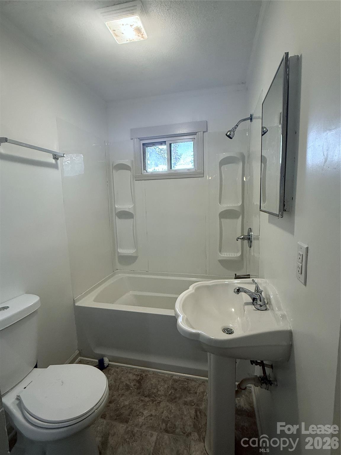 9225 Moores Chapel Road Charlotte, NC 28214 - Photo 15 of 19 a bathroom with a sink a toilet and shower