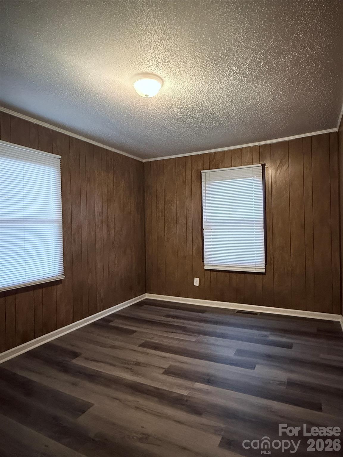 9225 Moores Chapel Road Charlotte, NC 28214 - Photo 17 of 19 a view of an empty room with wooden floor and a window