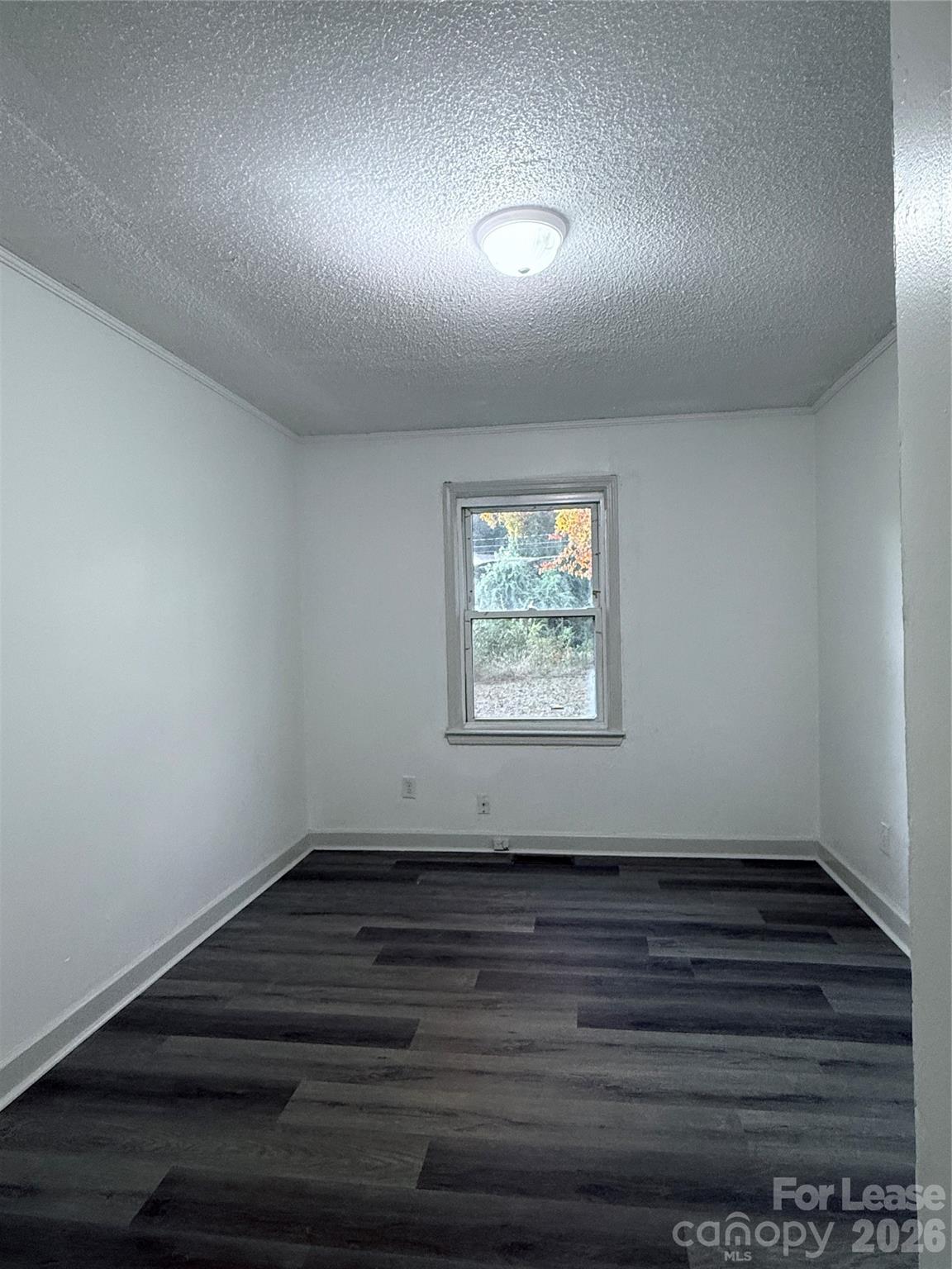 9225 Moores Chapel Road Charlotte, NC 28214 - Photo 18 of 19 an empty room with wooden floor and windows