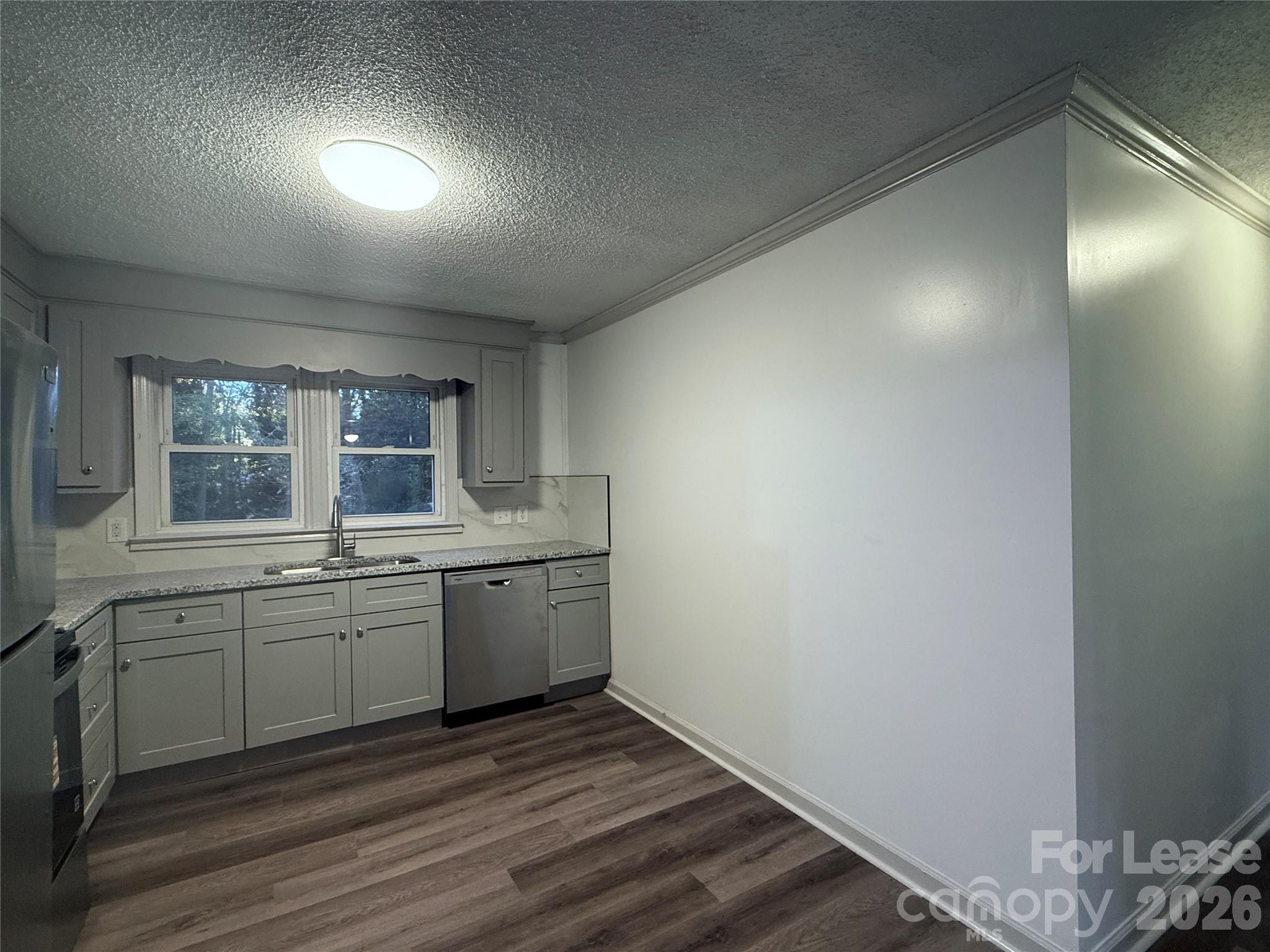 9225 Moores Chapel Road Charlotte, NC 28214 - Photo 9 of 19 a view of a kitchen with sink dishwasher and wooden floor