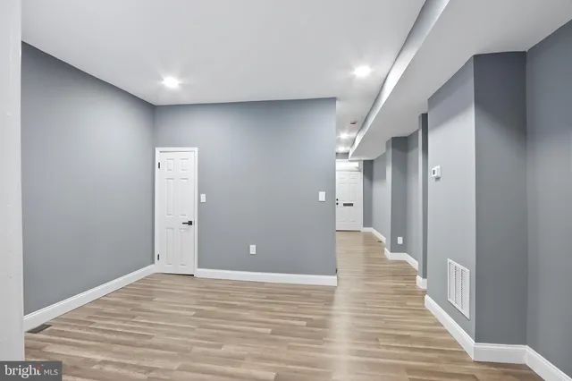 a view of a hallway with wooden floor