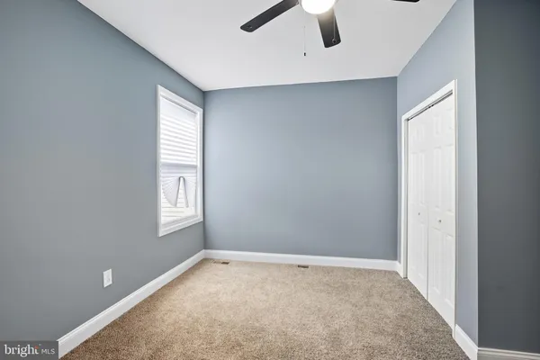an empty room with windows and closet