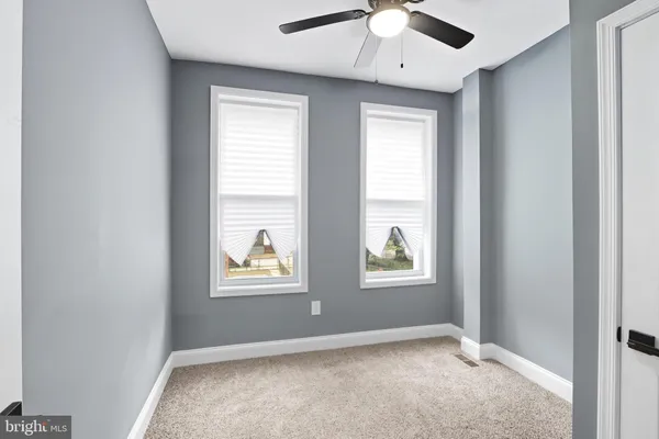 an empty room with windows and closet