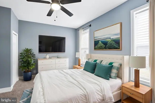 a bedroom with a bed and a wooden floor