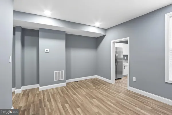 an empty room with closet and wooden floor